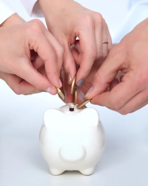 Putting coin into the piggy bank — Stock Photo, Image