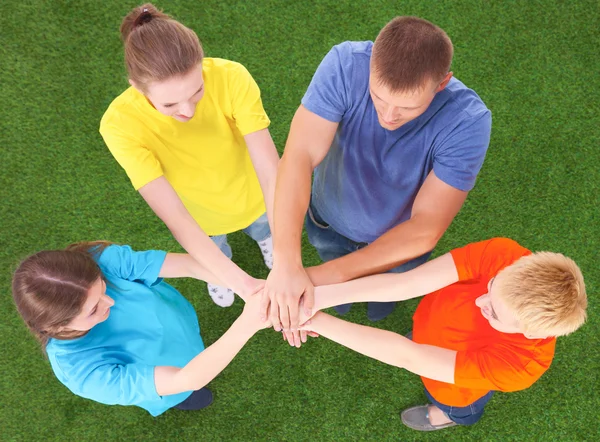 People joining their hands  on green grass — Stock Photo, Image