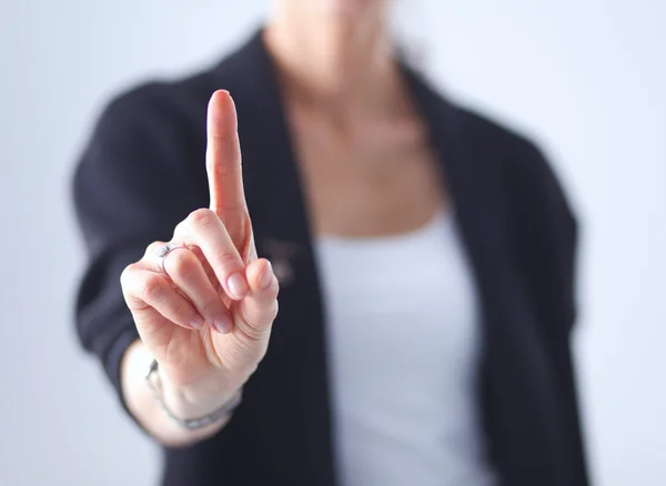 Vrouw die een denkbeeldig scherm met haar vinger aanraakt - geïsoleerd — Stockfoto