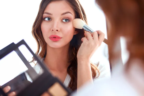 Young beautiful woman making make-up near mirror — Stock Photo, Image