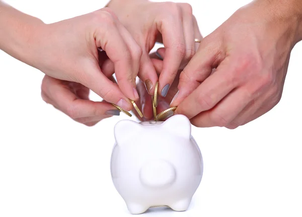 People putting coin into the piggy bank — Stock Photo, Image