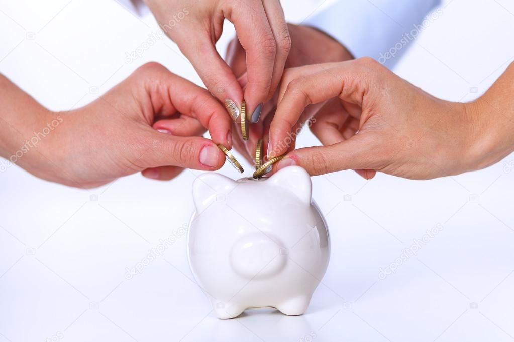 People putting coin into the piggy bank