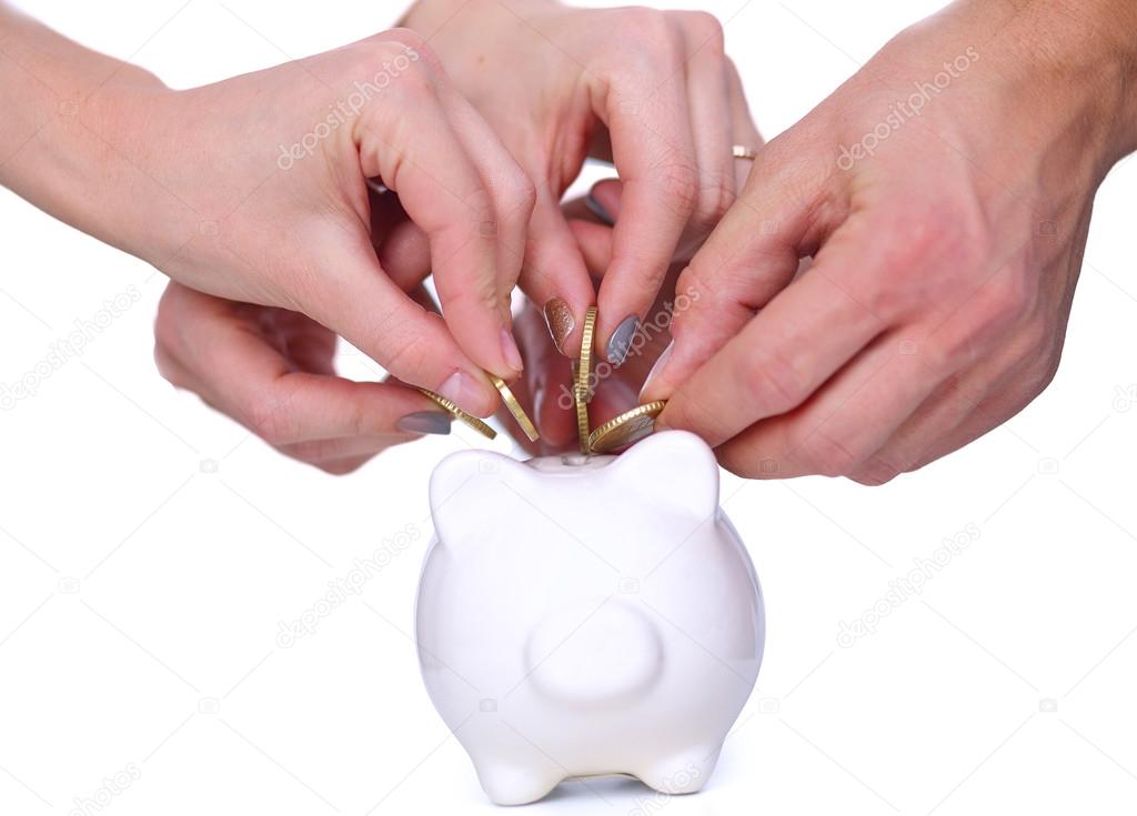 People putting coin into the piggy bank