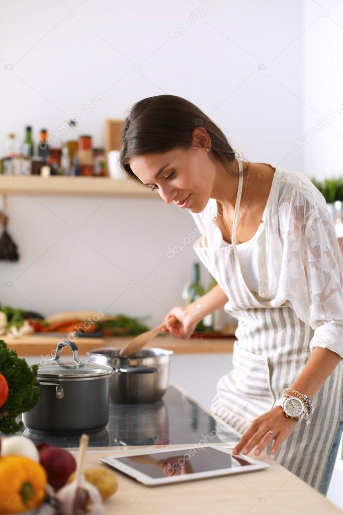 Using A Tablet Computer To Cook In Kitchen Using A Tablet Computer To Cook In Kitchen