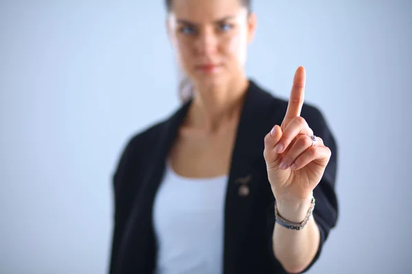 Mujer tocando una pantalla imaginaria con su dedo — Foto de Stock