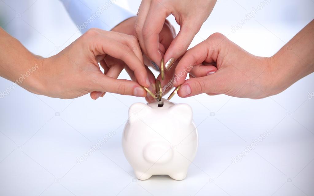 People putting coin into the piggy bank