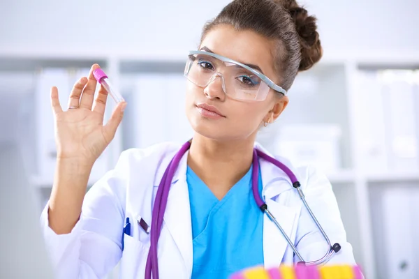 Woman researcher is surrounded by medical vials and flasks, isolated on white background — Stock Photo, Image