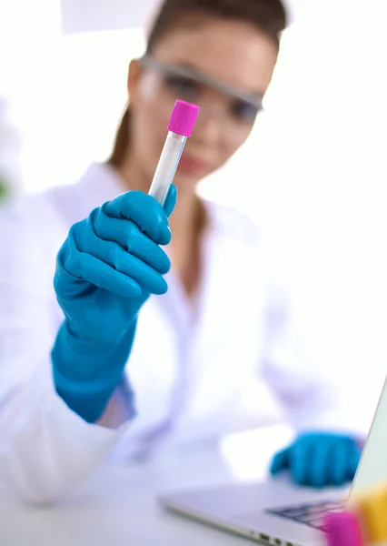 Woman researcher is surrounded by medical vials and flasks, isolated on white background — Stock Photo, Image