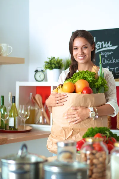 Mujer joven sosteniendo bolsa de la compra de comestibles con verduras —  Fotos de Stock