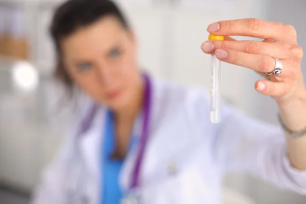 Woman researcher is surrounded by medical vials and flasks, isolated on white background — Stock Photo, Image