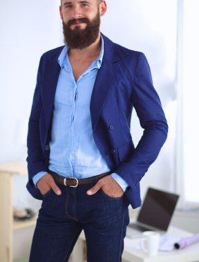 Ayakta, gri arka plan üzerinde izole yakışıklı adam portresi