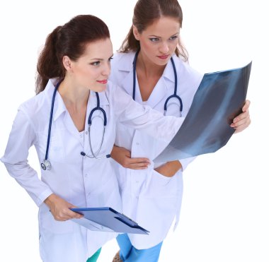 Röntgen filmini izleyen iki kadın hemşire, hastanede duruyor.