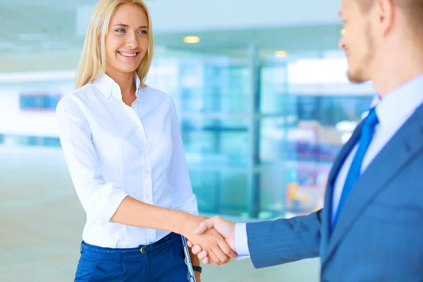 Two successful business people shaking hands with each other