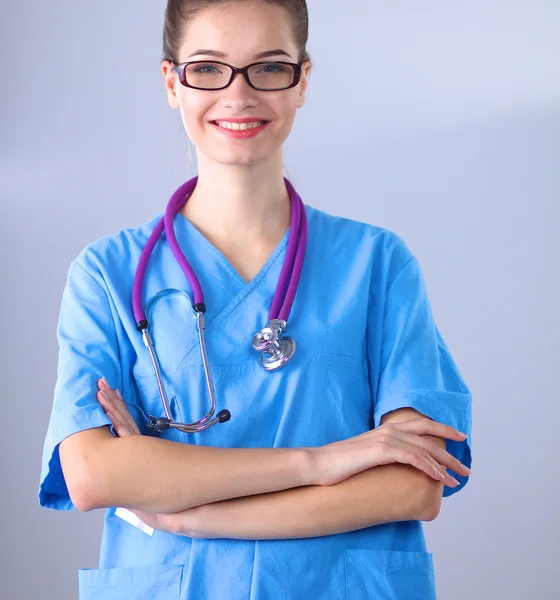 Usmívající se doktorka se složkou v uniformě stojící v nemocnici — Stock fotografie