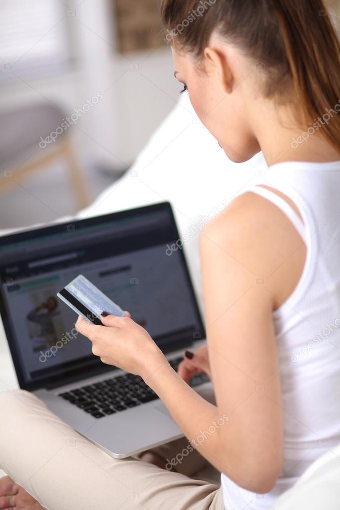 Woman shopping online with credit card and computer.Internet Shopping