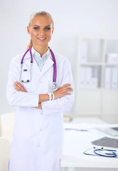 Portrait of young woman doctor with white coat standing in hospital — Stock Photo, Image