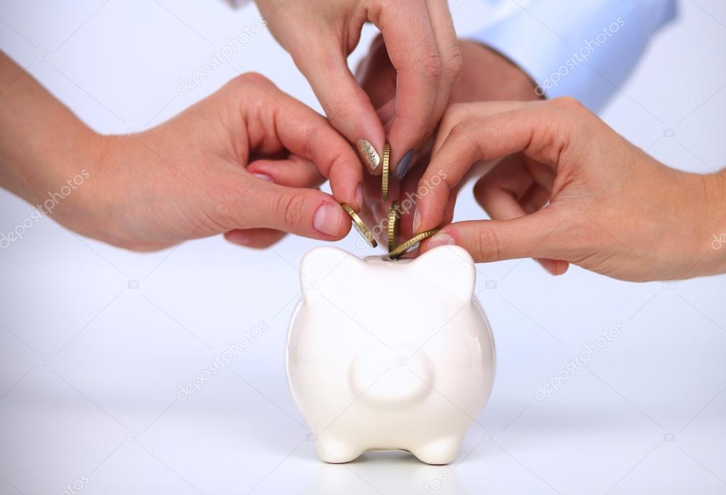 People putting coin into the piggy bank