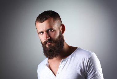 Ayakta, gri arka plan üzerinde izole yakışıklı adam portresi