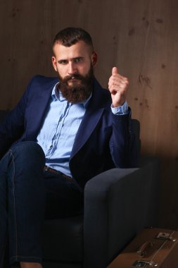 koyu arka plan üzerinde izole sofa ofis lobisinde oturan işadamı