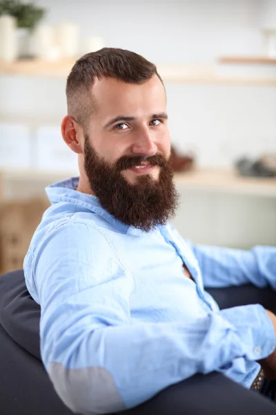 Jonge zakenman zit op stoel in functie — Stockfoto