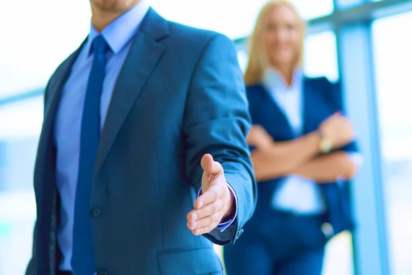 Joven hombre de negocios listo para apretón de manos de pie en la oficina — Foto de Stock