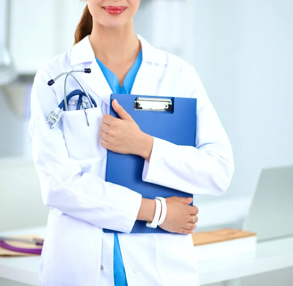 Portrait of young woman doctor with white coat standing in hospital — Stock Photo, Image