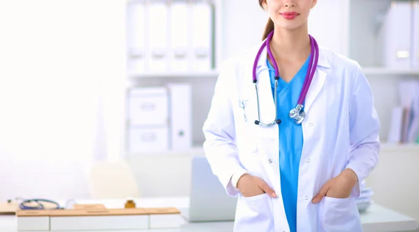 Portrait of young woman doctor with white coat standing in hospital — Stock Photo, Image