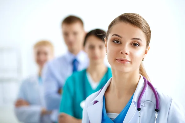 Attractive female doctor in front of medical group — Stock Photo, Image