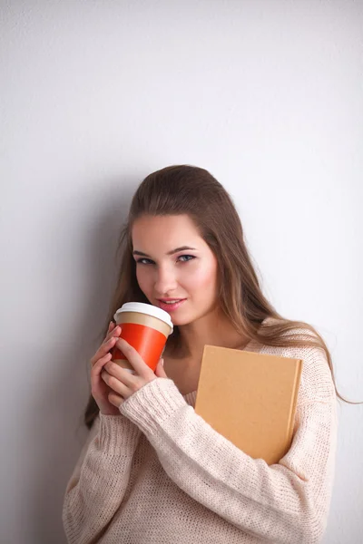 Portrait  a young woman with cup of tea or coffee, holding book — Stock Photo, Image