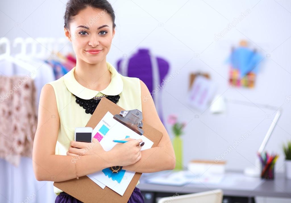 Modern young fashion designer working at studio.