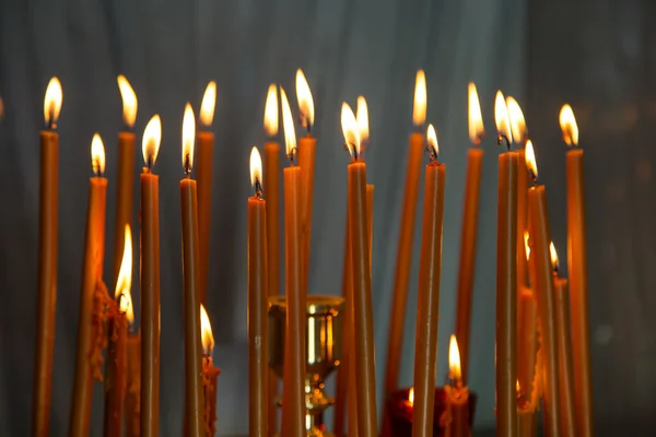 Burning wax candles in the church background — Stock Photo, Image