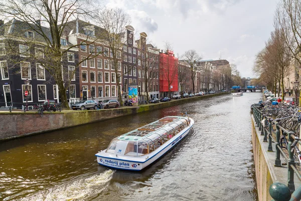 Cruise boat at Amsterdam canals in Holland, street view