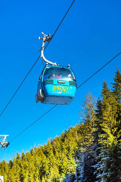 Close up Bansko cable car cabin, pine trees  against vibrant blue sky, Bulgaria — Stock Photo, Image