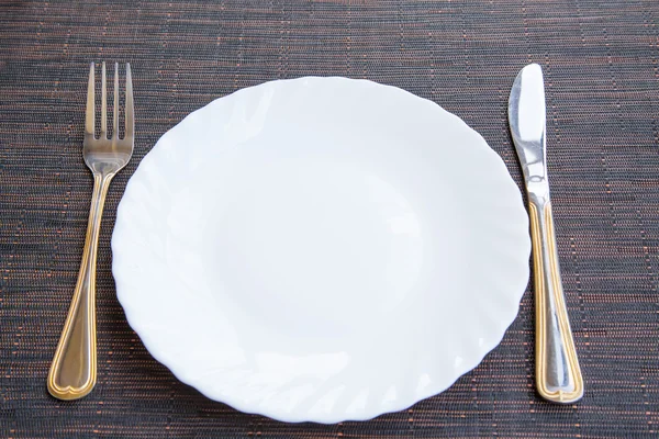 Empty plate, fork and knife — Stock Photo, Image