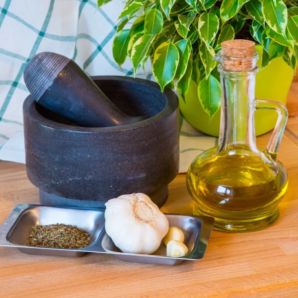 Bottle of olive oil, mortar and pestle — Stock Photo, Image