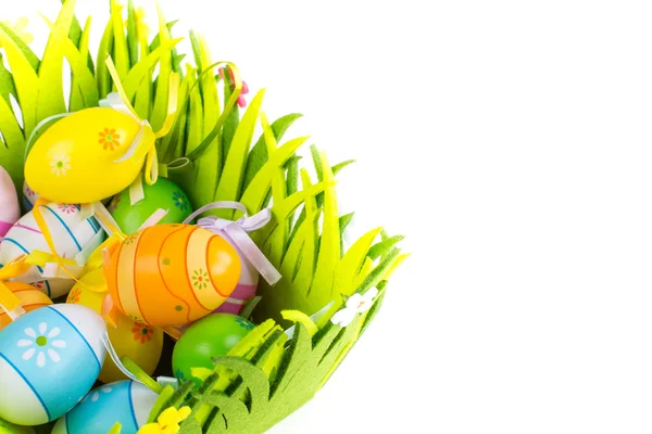 Green grass box with Easter eggs on white background — Stock Photo, Image