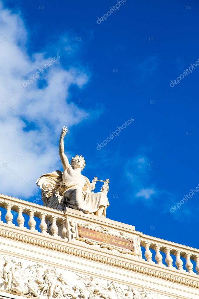Sky background with Statue at the front facade of Burgtheater, Vienna