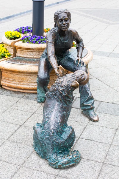 Estatua de bronce de una niña jugando con su perro junto al río Danubio . — Foto de Stock