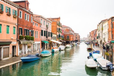 Canal in Murano island, street and boats 