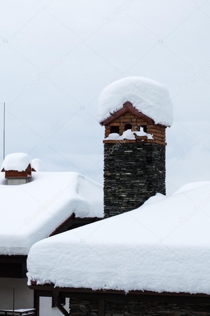Snow covered chimney and roof