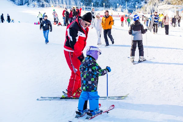 Het kind leren ski en man op de helling in Bansko, Bulgarije — Stockfoto