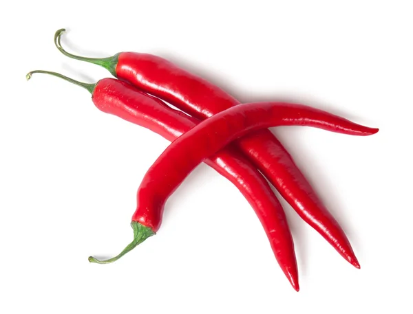 Three juicy red ripe sharp intersecting chili peppers — Stock Photo, Image