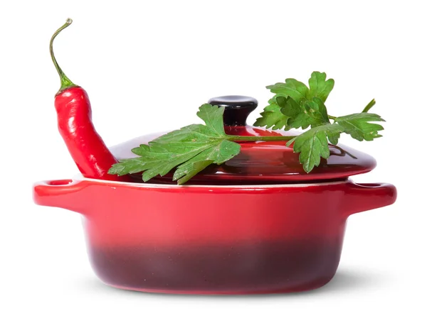 Red pepper in saucepan with lid and parsley on top — Stock Photo, Image