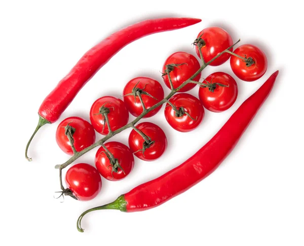 Two chili pepper and cherry tomatoes on stem top view — Stock Photo, Image