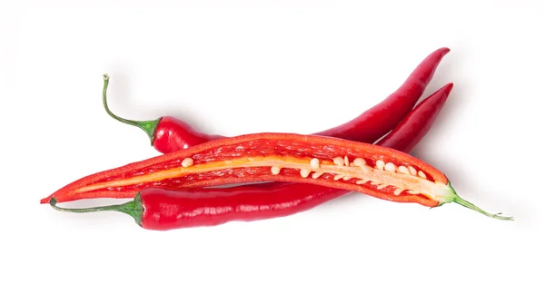 Two whole and one half red chili peppers — Stock Photo, Image