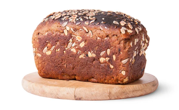 Unleavened bread with seeds on wooden board — Stock Photo, Image