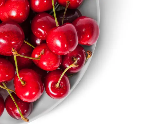 Closeup red sweet cherries in white plate top view — Stock Photo, Image