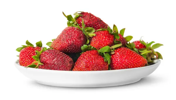 In front pile of fresh juicy strawberries on white plate — Stock Photo, Image