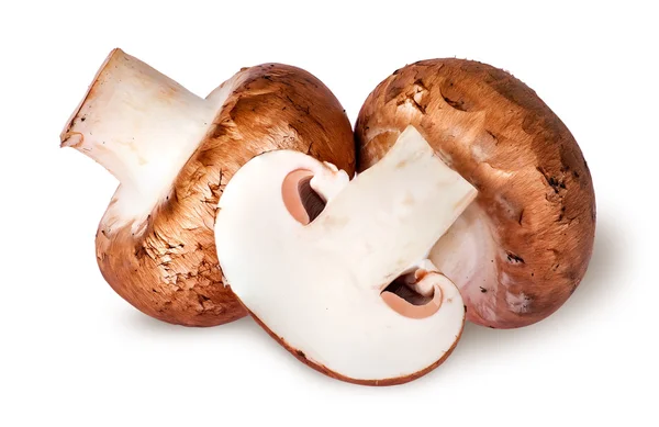 Two whole and half brown champignons — Stock Photo, Image