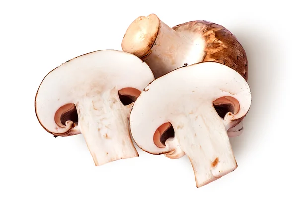 Whole and two half brown champignons — Stock Photo, Image
